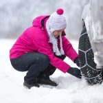 woman  installing snow chain
