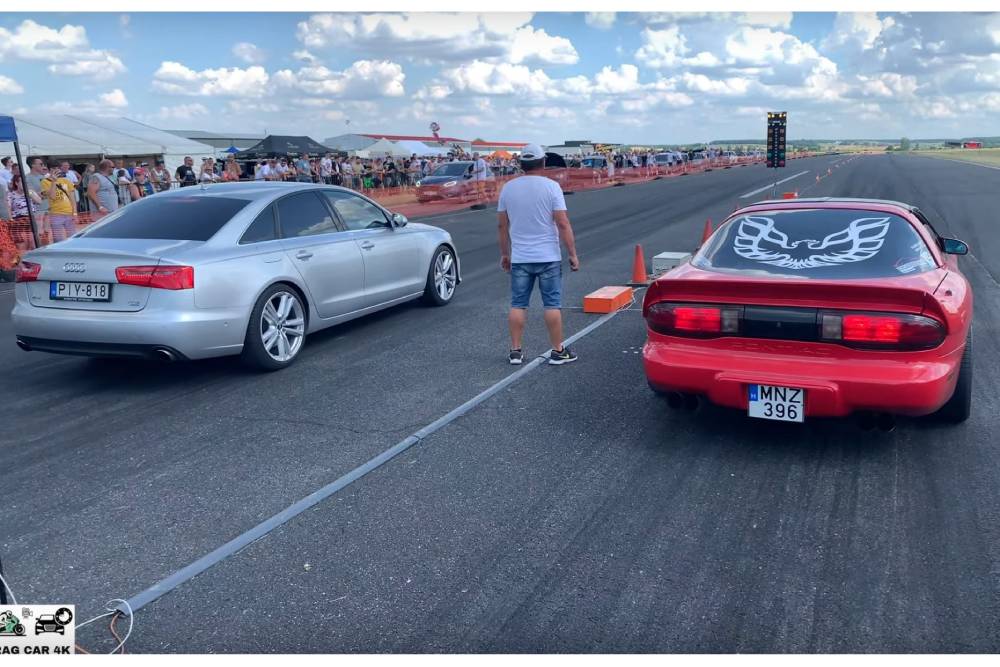 https://autogreeknews.gr/wp-content/uploads/2021/12/audi-a6-drag-races-pontiac-firebird-trans-am-both-.jpg
