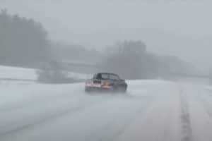 mazda mx-5 driving top down in a blizzard